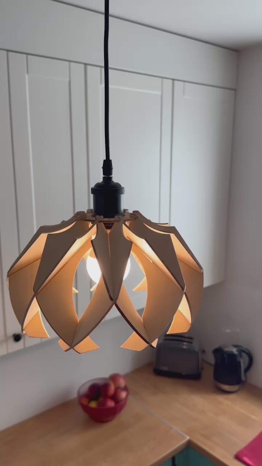 Short video showcasing different views of handcrafted small wooden pendant lamps with a modern flower-like design, highlighting the intricate craftsmanship, eco-friendly materials, and the beautiful light patterns they create.